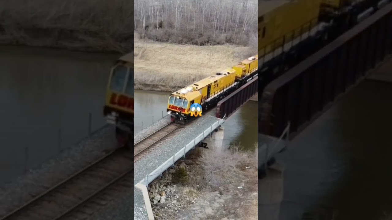 WOW! LORAM RAIL GRINDER HIGHBALLS OVER BRIDGE THRU CROSSING! #trains #drones #loram