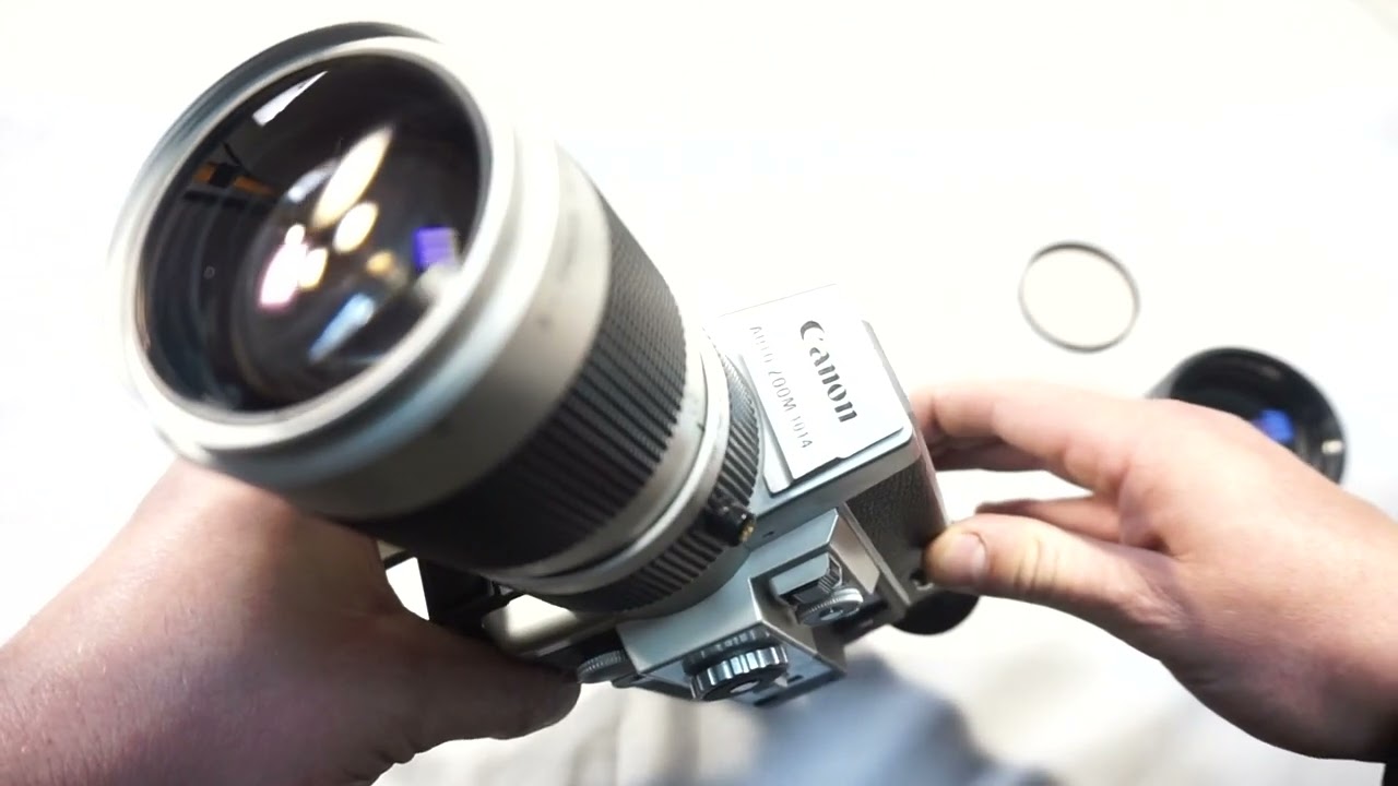Canon 1014 loading Super 8 film and batteries on Super 8 camera Canon Auto Zoom 1014 Electronic