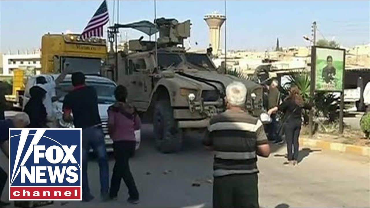 Kurdish protesters throw food, rocks at retreating US military
