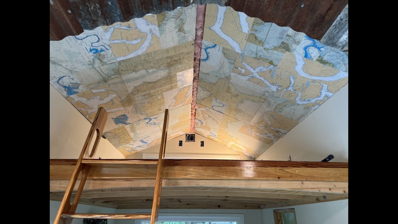 DIY build of library ladder wheels and nautical charts repurposed as wall paper for the tiny house.