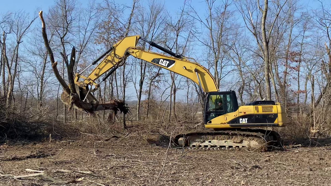 CAT 325D excavator doing some land clearing.