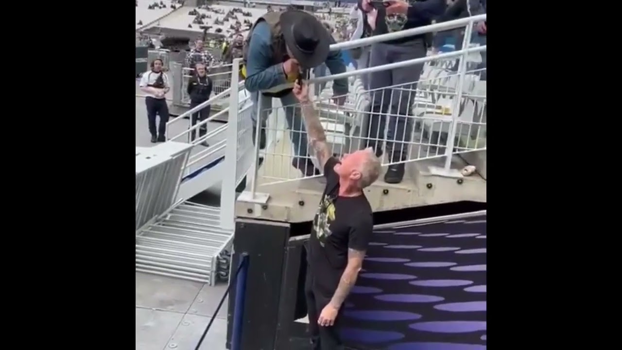 James Hetfield continues to light a cigar for a fan