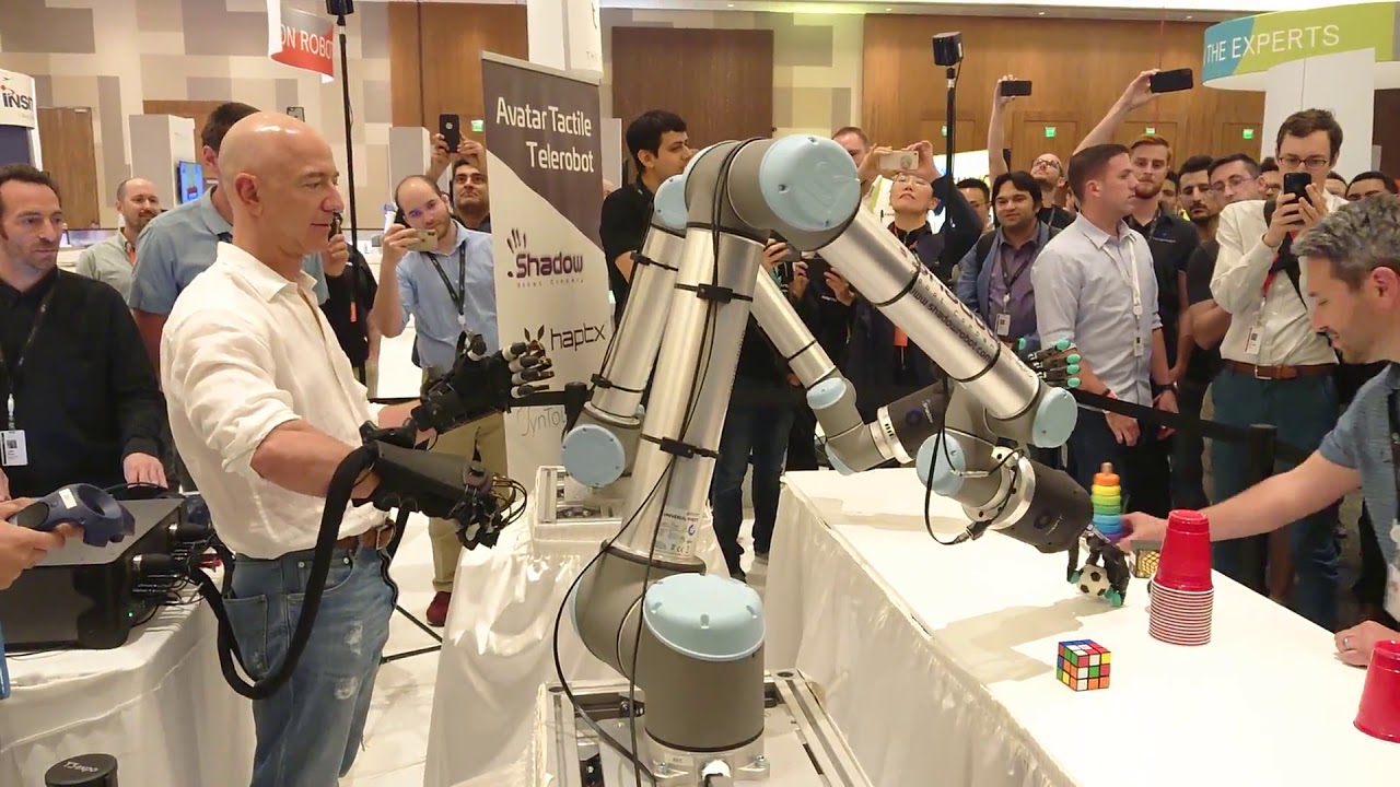 Amazon CEO Jeff Bezos Operates Robot Hands