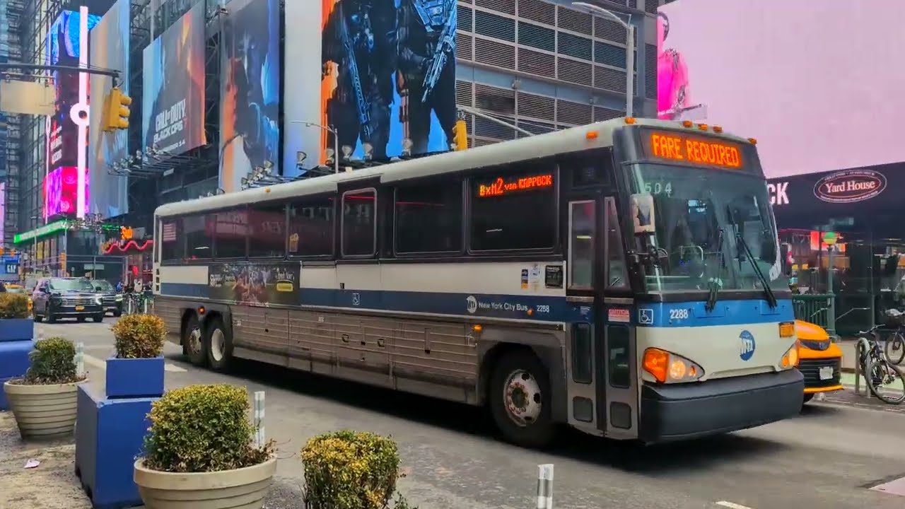 MTA & NYCT Bus: MCI D4500CT 2288 on BxM2 + UNIQLO Wrapped New Flyer XD40 7614 on M20 @ 7 Ave & 41 St