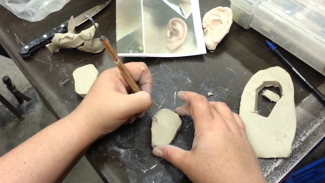 Sculpting an ear in clay