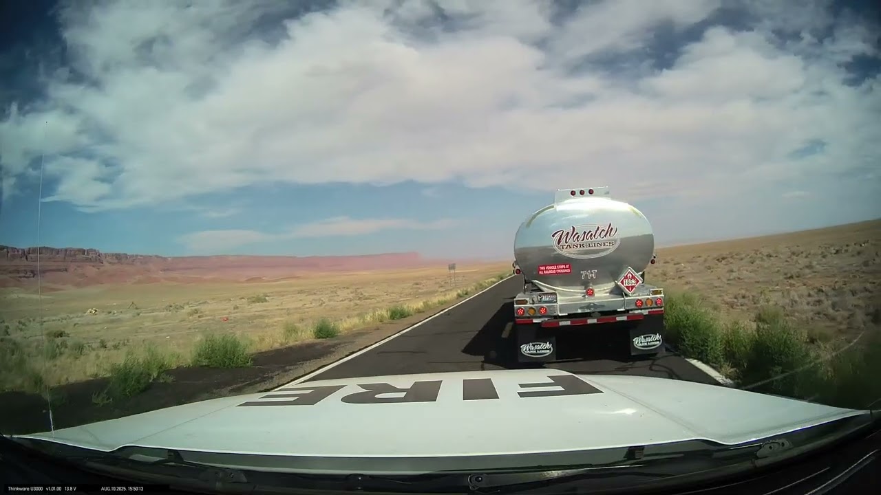 Semi truck dragging chain, sparking alongside road while Dragon Bravo fire was raging nearby.