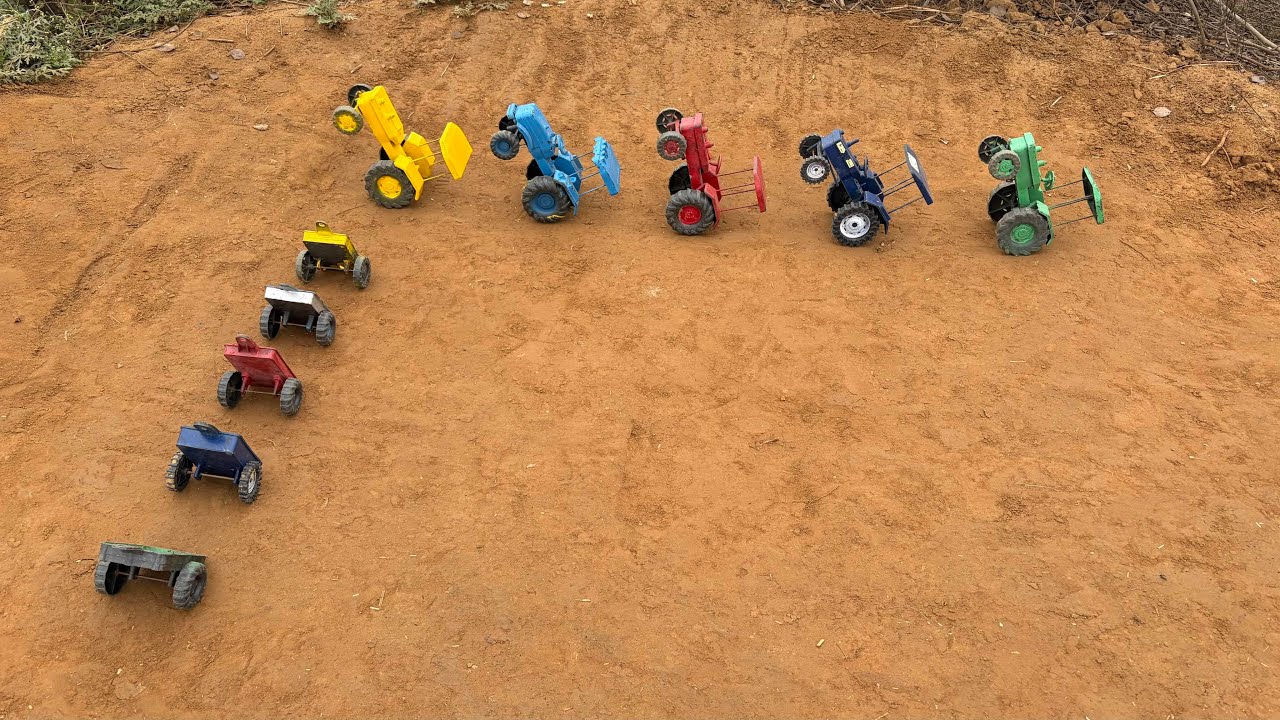 The tractors and trailers are all standing upright, with the trailers full of soil.#178