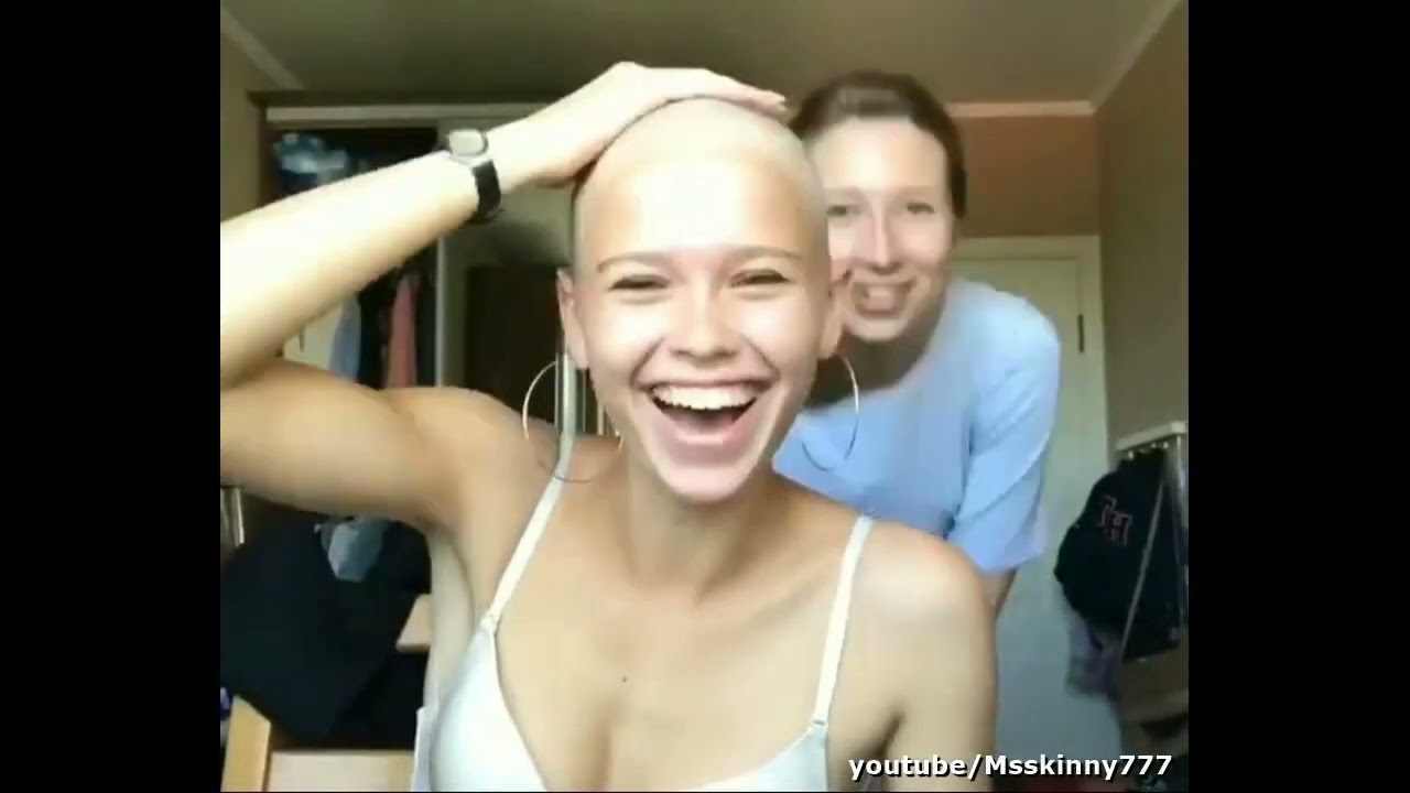 Beautiful bald girl shaving her head