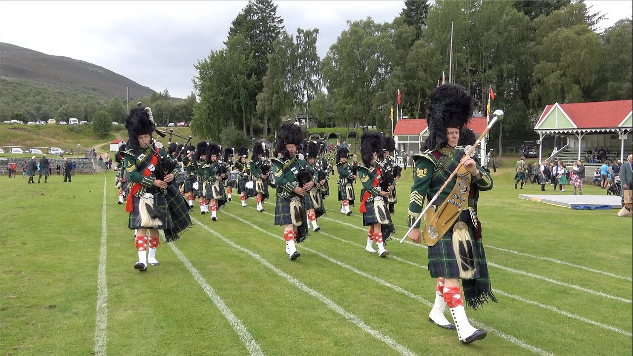 Drum Major Dean leading Huntly Pipe Band on the march for 2021 Grampian Games in Braemar, Scotland