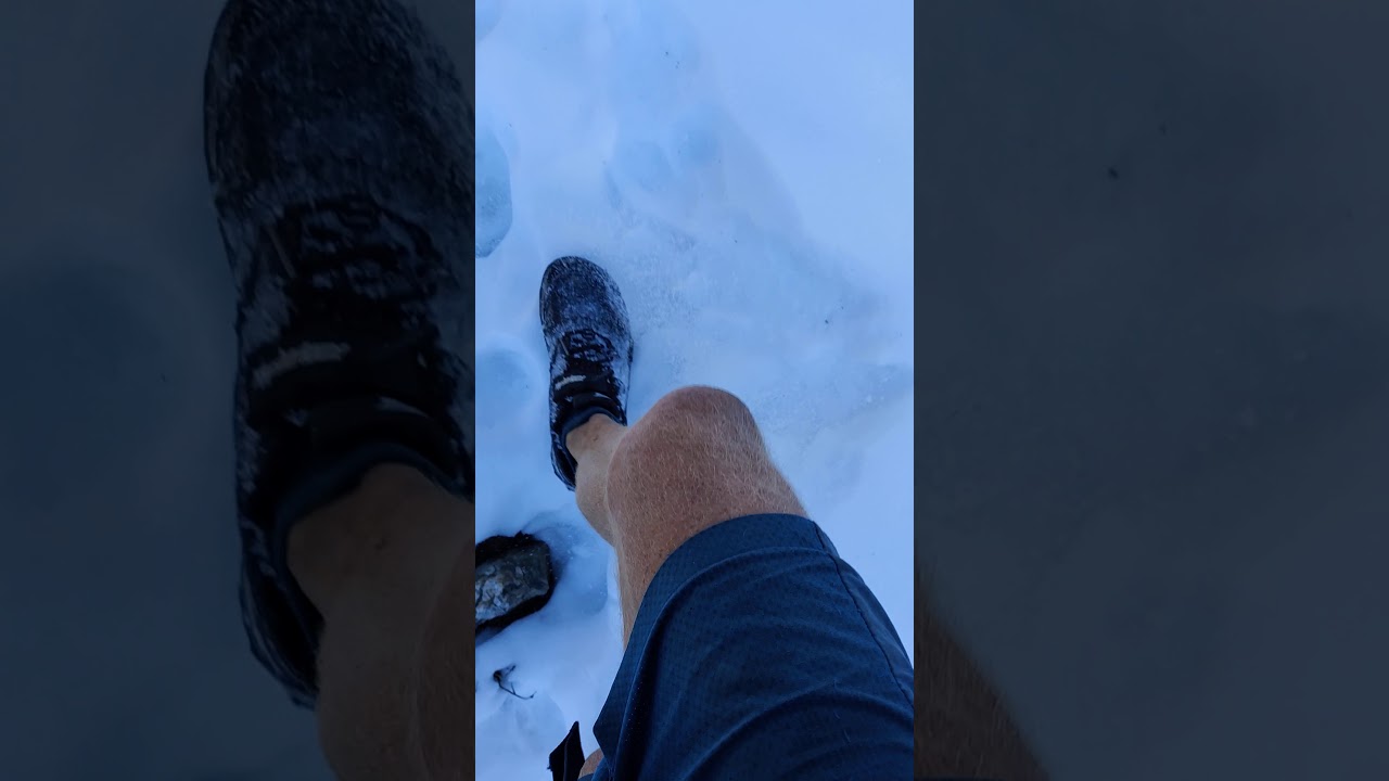 Walking on a snow covered pathway above Masar Tal lake to Manjoli hamlet