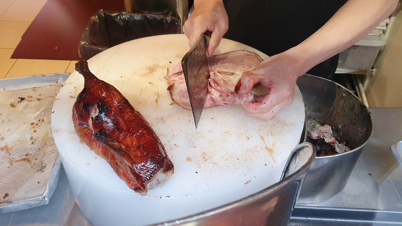 Amazing professional chopping of a Beijing duck Cantonese roast duck Chinese Asian Cooking