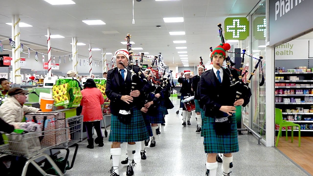 Festive surprise as Newtonhill Pipe Band march through Asda in Portlethen Scotland, Christmas 2019