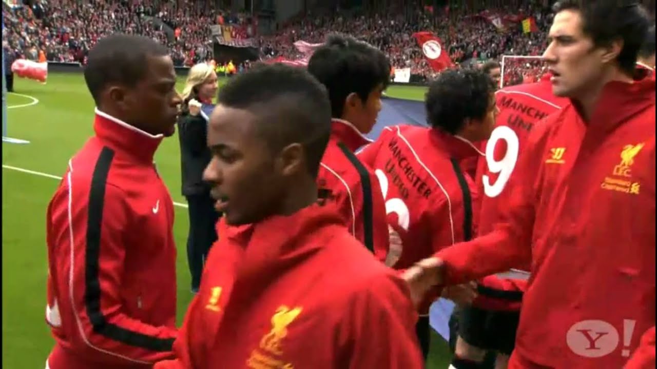 Suarez and Evra shake hands