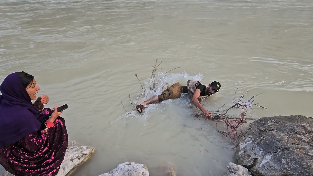 The falcon falls into the river and Leila cries for the falcon.
