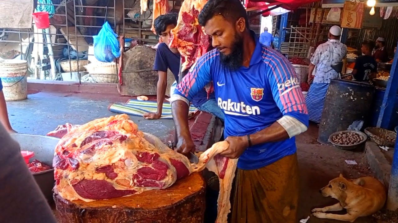 Beef cutting skills by profeessional butcher at roadside meat shop.Big cow meat cutting skills.