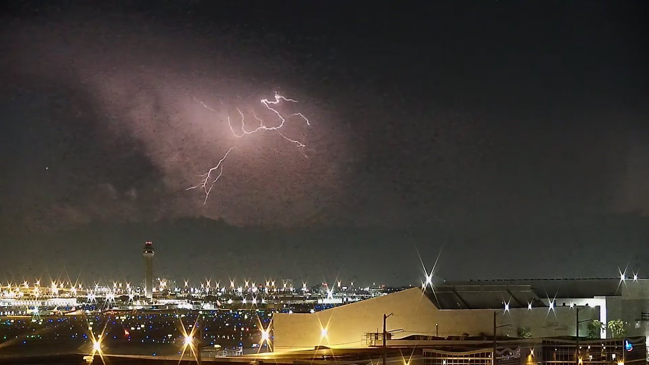 Lightning fills the sky over Miami International while aircraft are landing