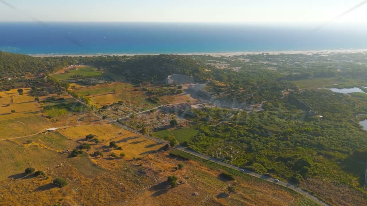 Gelemis, Turkey. Aerial drone view of Patara Ancient Theatre, Colonnaded Street, Kursulu Hill, Pa...