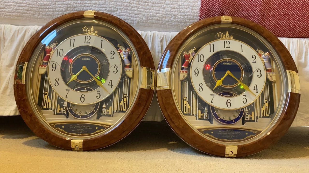 Both Generations Of QXM128BRH - Seiko Melodies In Motion Wall Clock