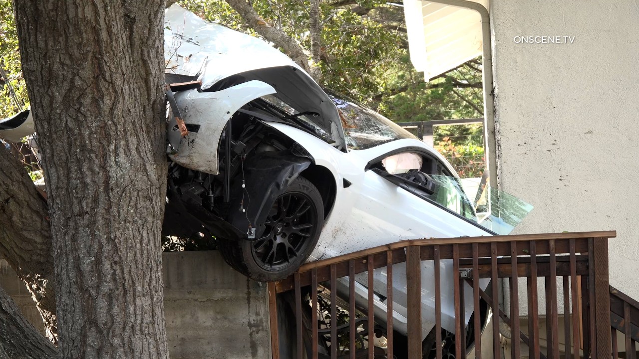 Tesla Wedged Between House and Tree Following Crash