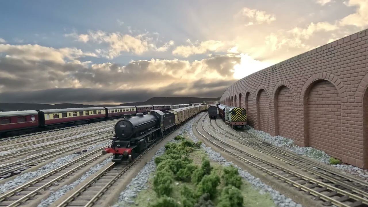 Model railway, authentic squeaky clanking rolling stock, decent length trains, moving cloudy skies