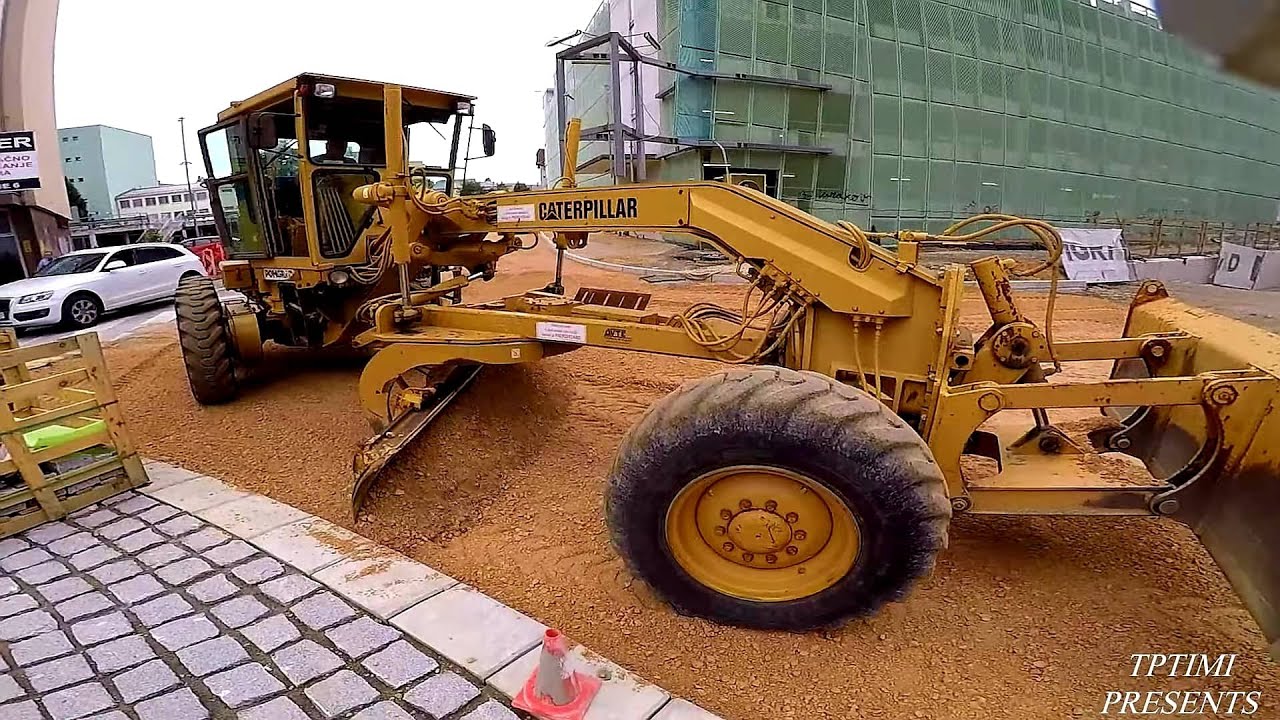 CAT Motor Grader Grading The Roundabout In The City-Skilled Operator