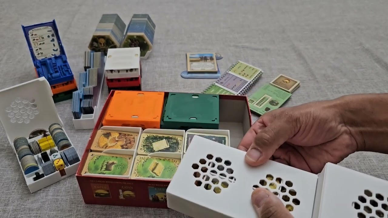I designed and 3d printed an organizer for Catan, the 4 expansions, and their extensions.