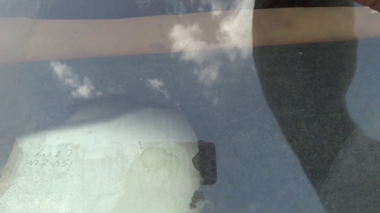 CAR GLASS CLEANING WITH SHARP BLADE. Wind shield cleaning and maintenance.