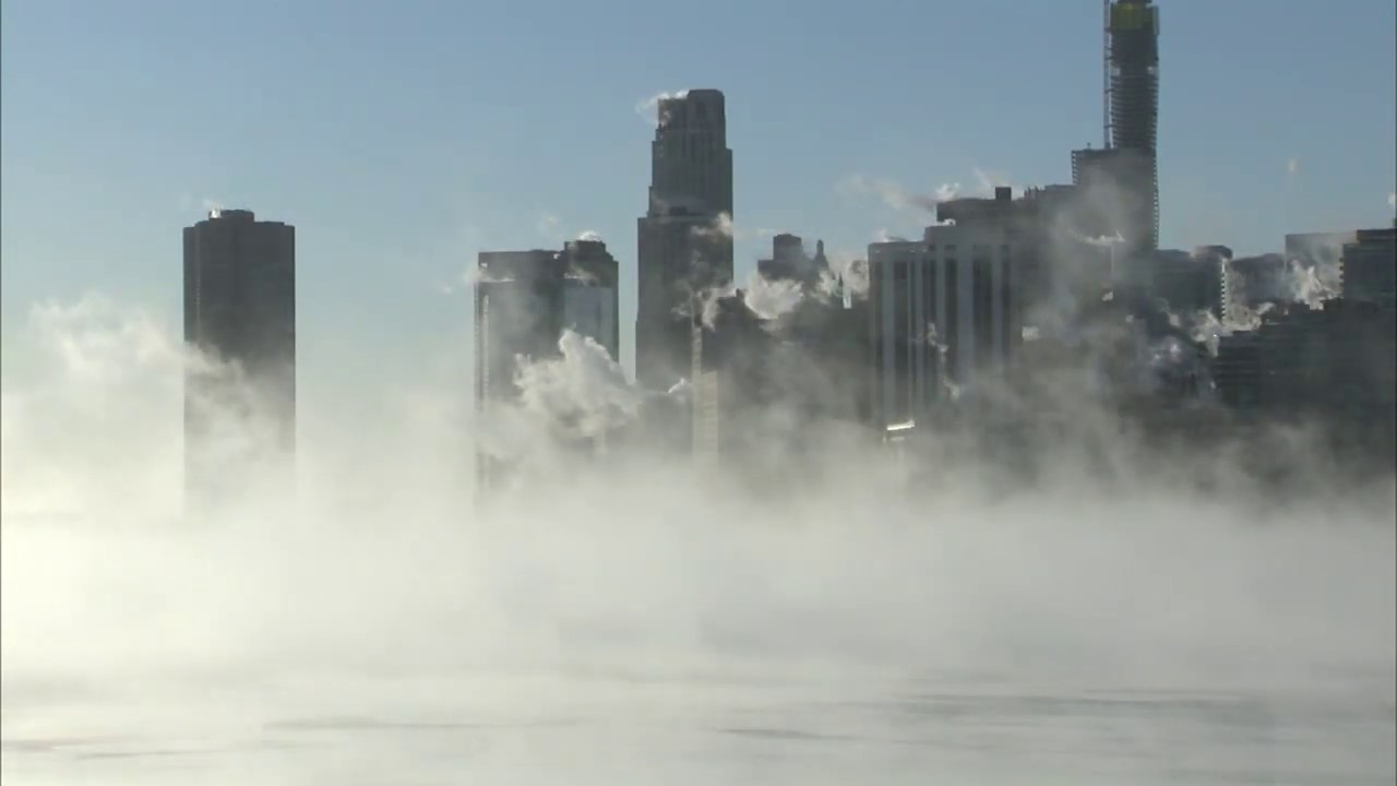 Steam rises from frozen Lake Michigan during historic cold