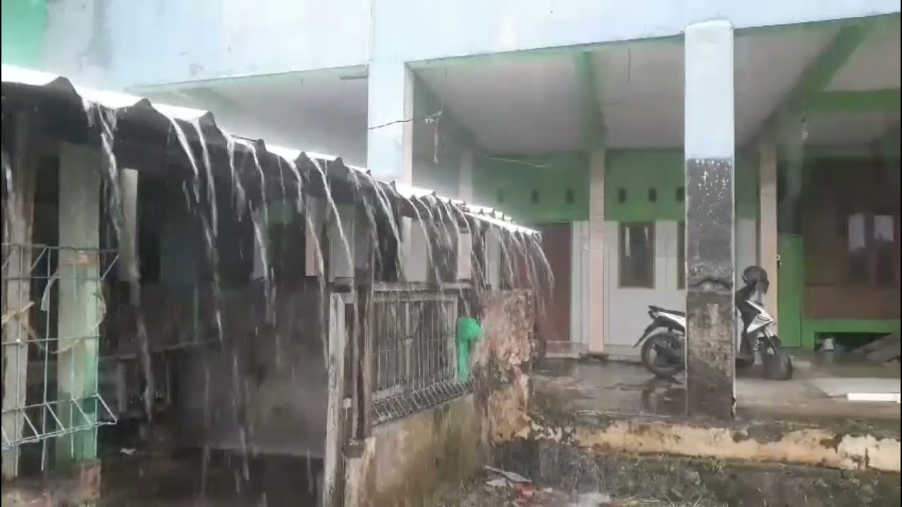 Heavy rain is pouring down on the roofs of houses in a village; the rain is perfect for therapy. 