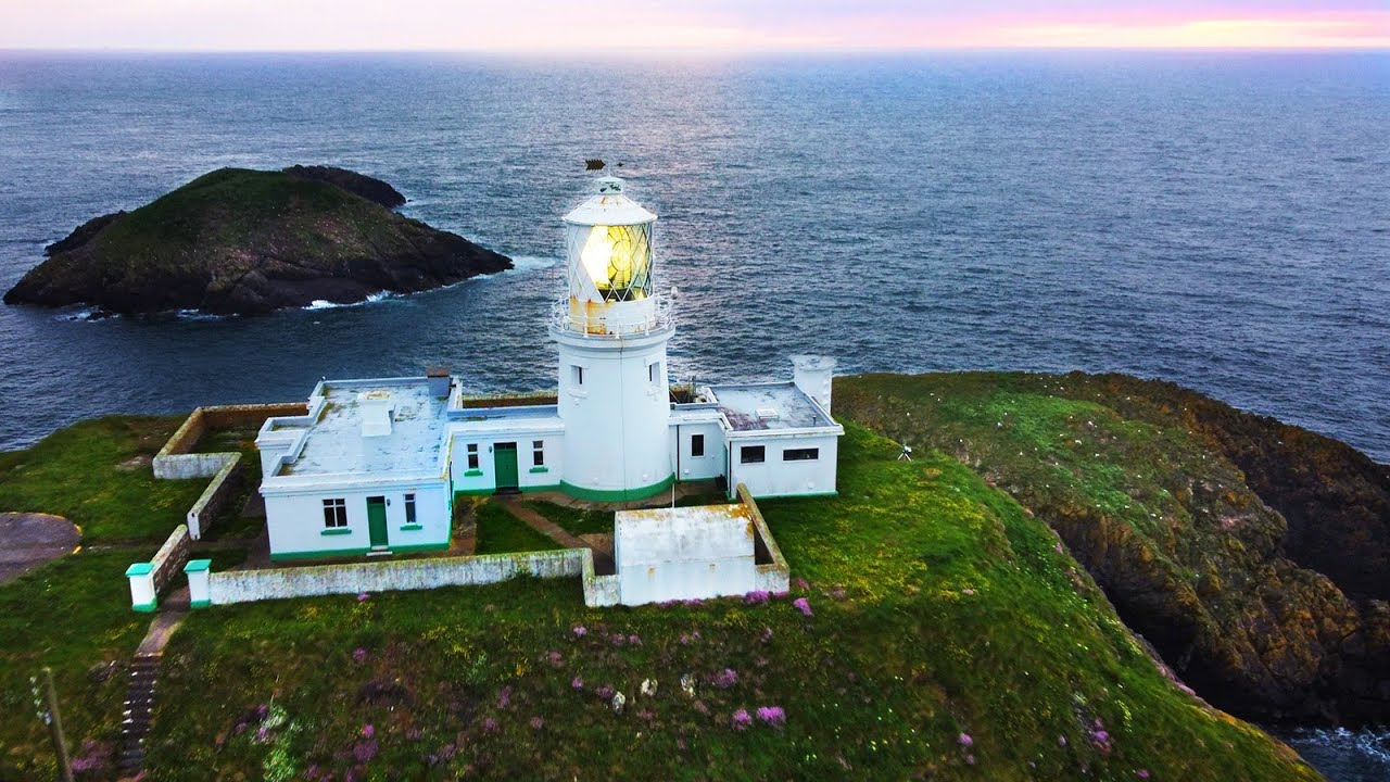 4K Strumble Head Lighthouse Pembrokeshire Wales drone aerial from the North East