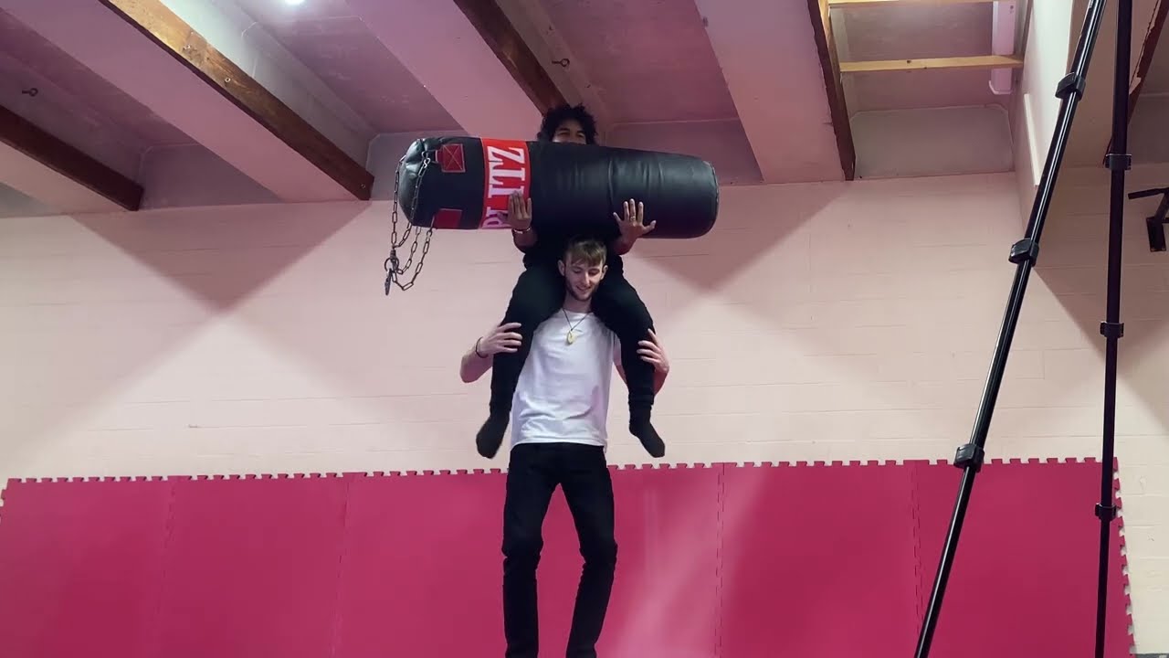 Shoulder ride with boxing bag