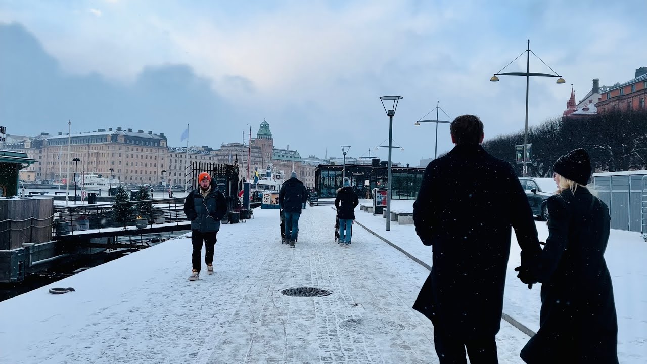 Stockholm Walks: Karlaplan - Strandvägen. Falling snow over Stockholm streets in February.