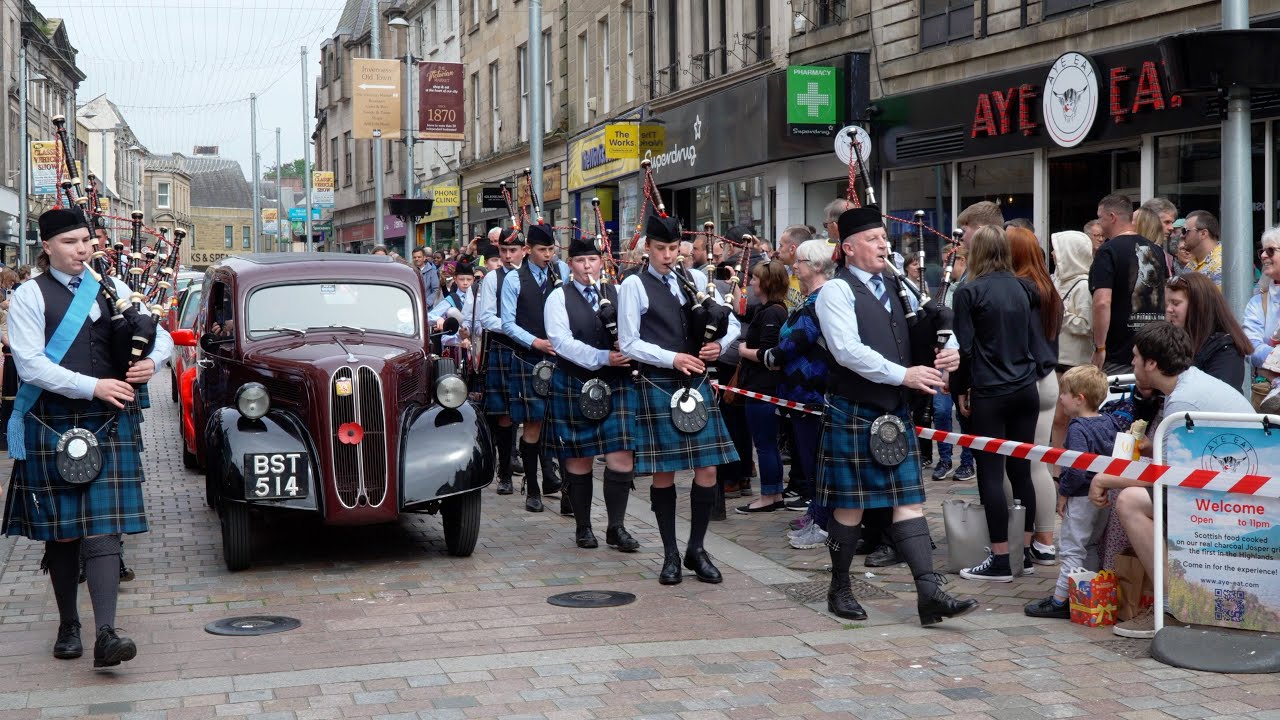 City of Inverness Youth Pipe Band march along High Street during 2024 Classic Vehicle Show