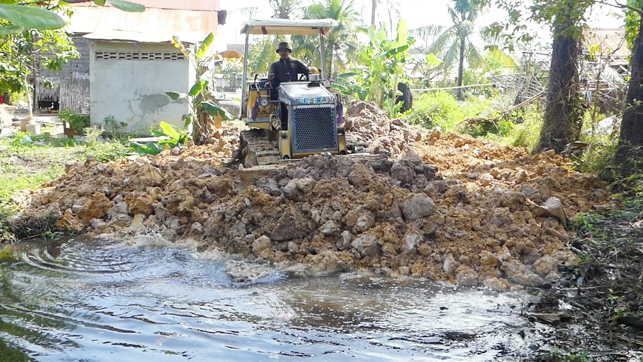 New Project Land Filling Up Construction With Dump Truck And Strong Dozer Pushing Soil Into Water