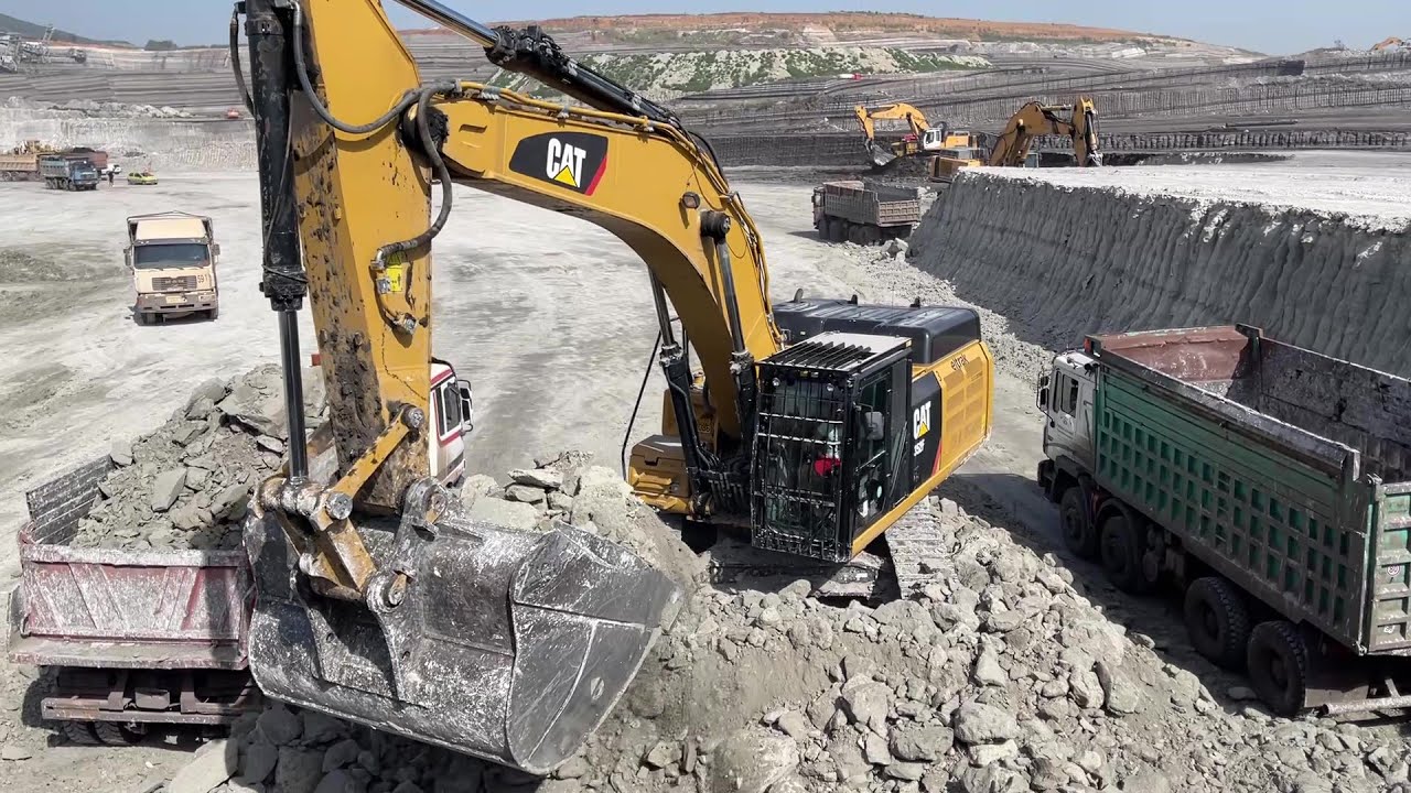 Caterpillar 352F Excavator Loading Mercedes And MAN Trucks On Huge Mining Site
