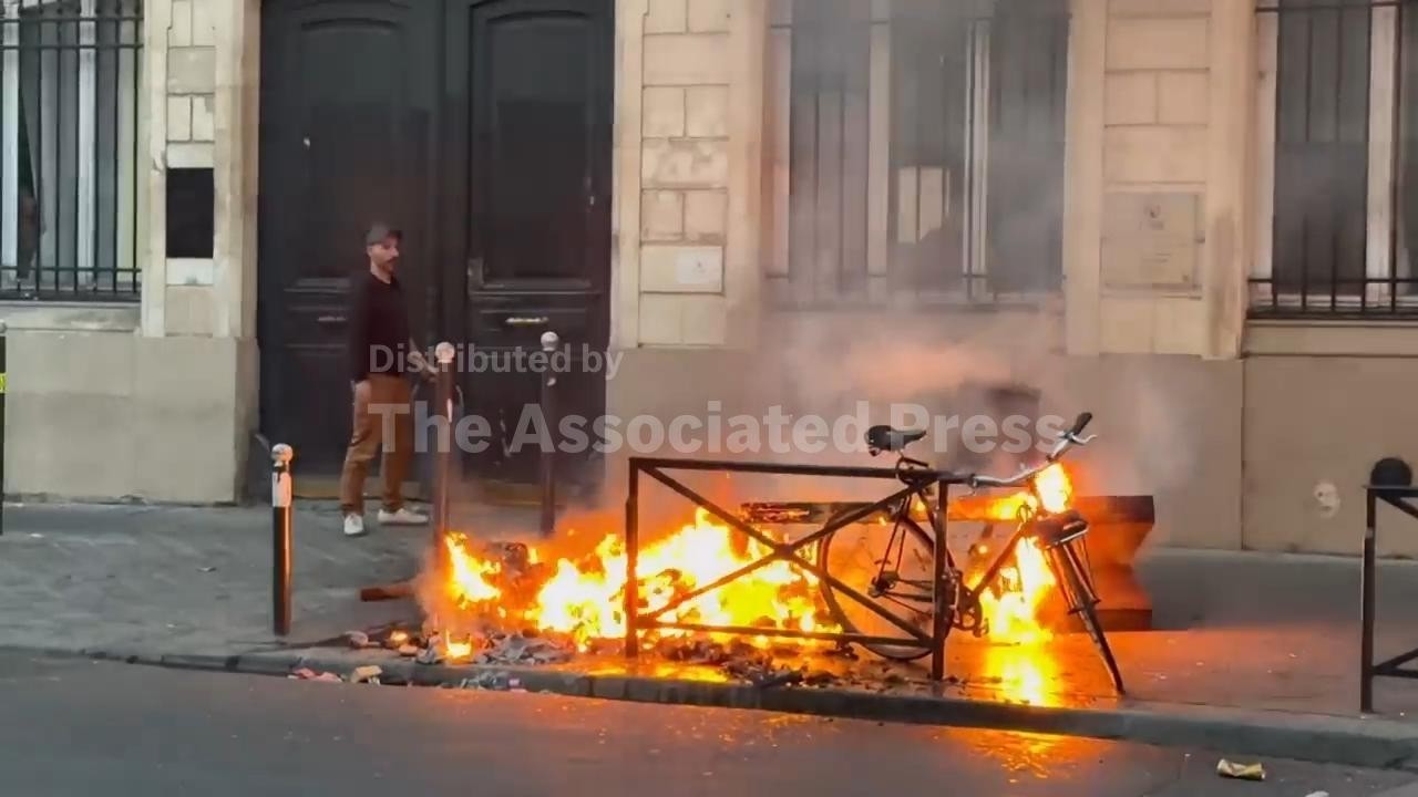 Fires set in Paris streets during protests, with businesses damaged and looting reported
