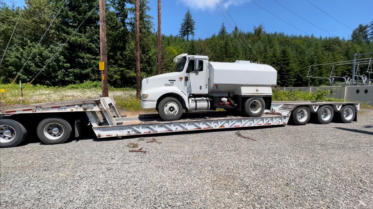 Hauling a water truck on a scissor neck lowbed