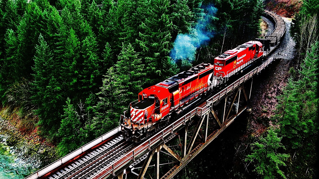 CP RAIL SD40 PULLS CONTINUOUS WELDED RAIL TRAIN BENDING THRU SHARP CURVES! 