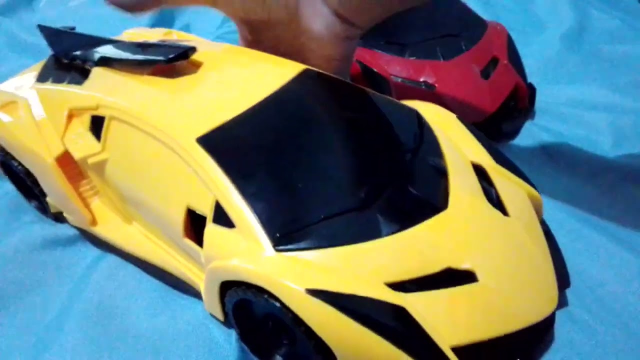 Two of broken veneno toys bump n go (one yellow) and (one red)