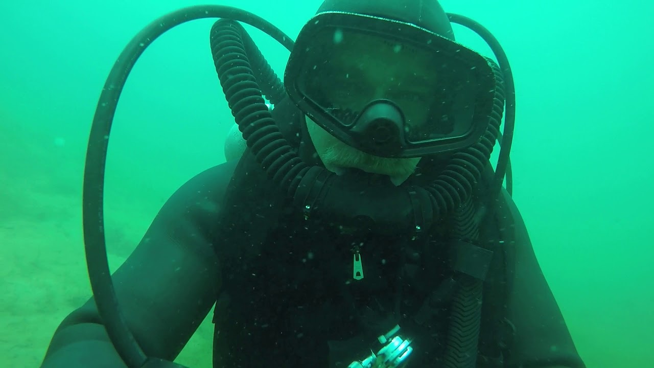Vintage scuba diving with vintage triple tanks and double hose regulators
