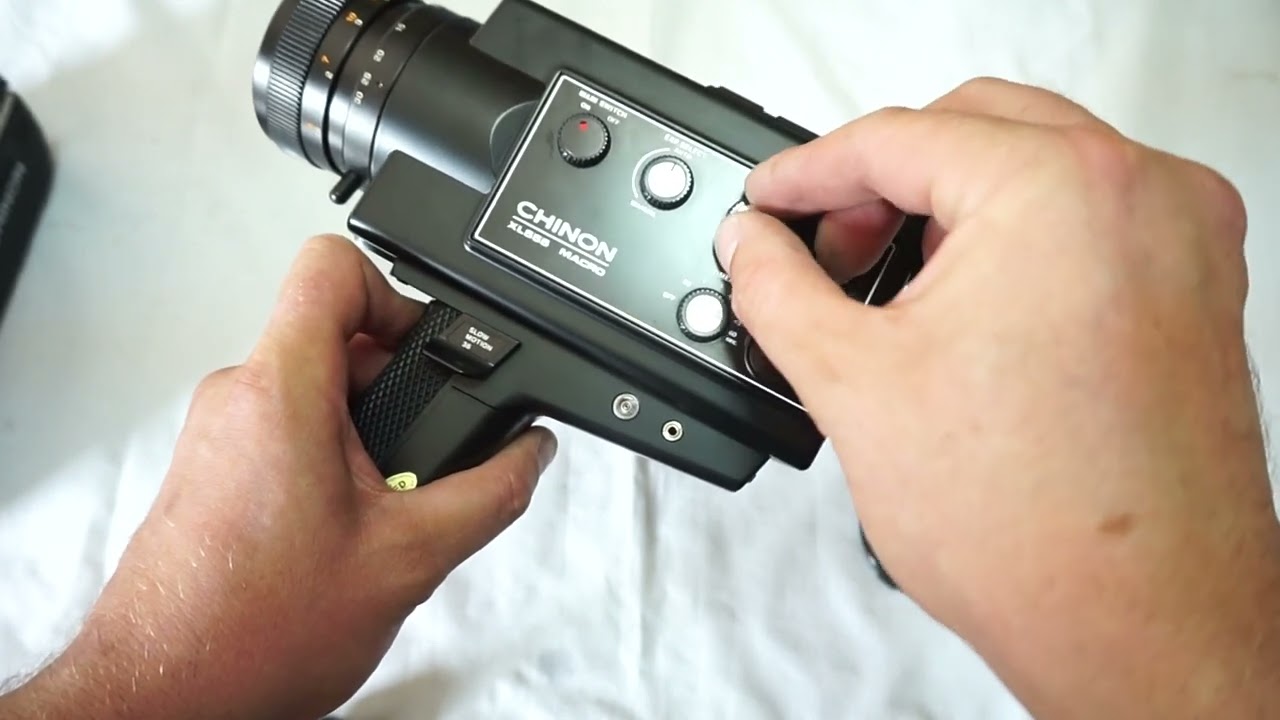 Chinon 555 loading Super 8 film and batteries on Super 8 camera Chinon 555 XL Macro Super 8
