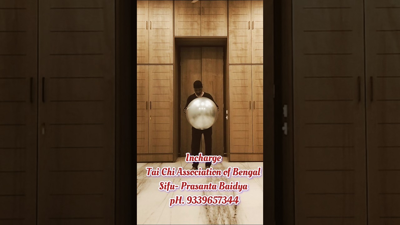 Tai Chi with a gym ball .