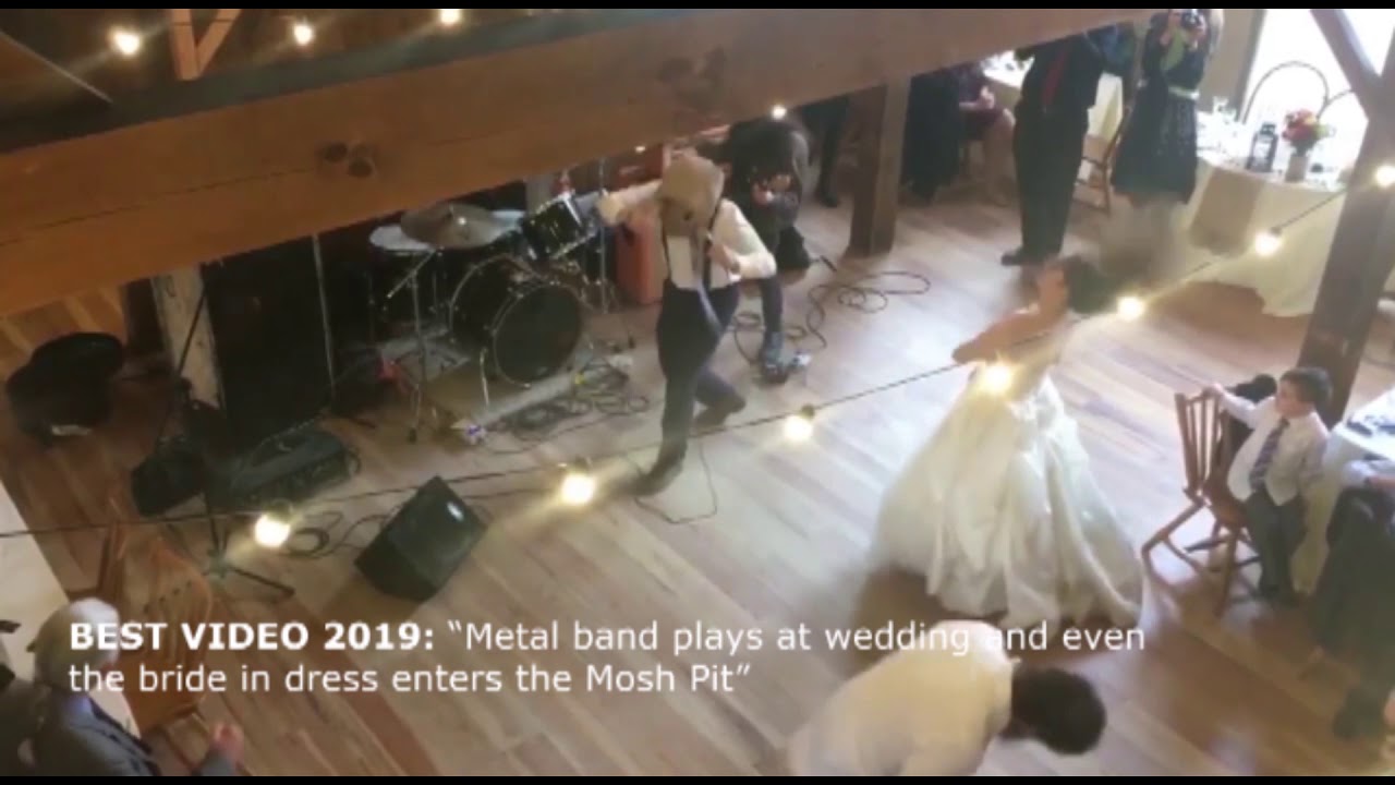 Metal band plays at wedding and even the bride in dress enters the Mosh Pit