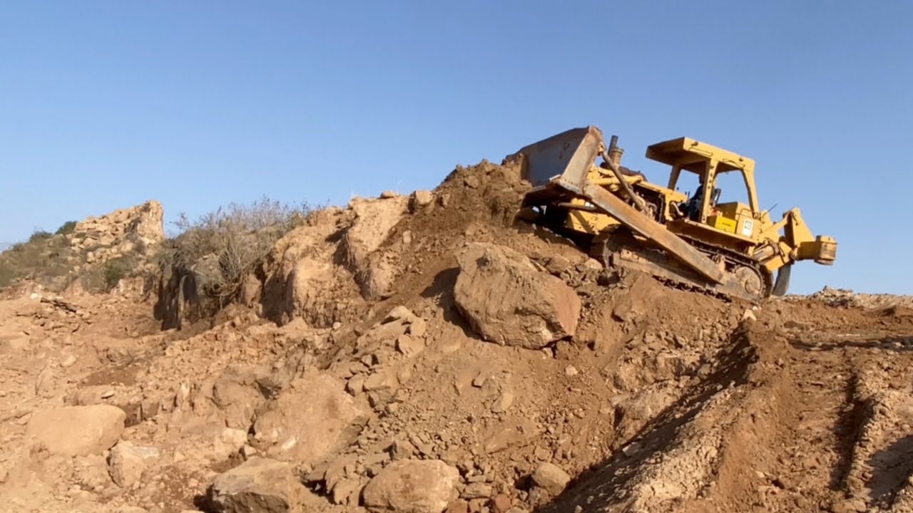 Caterpillar D8K Bulldozer Cutting Mountain