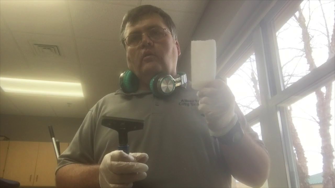 School janitor Window Cleaning with a squeegee. Custodian Training.