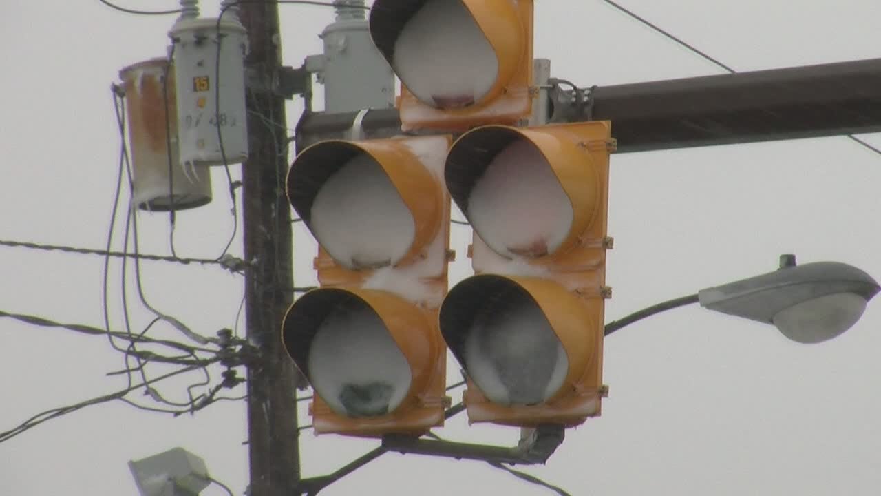 LED traffic lights clogged with snow as people run red lights