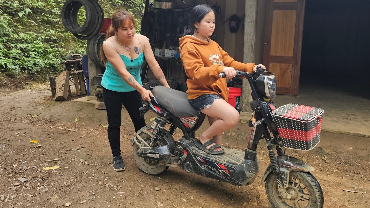 Mechanic girl helps little girl fix electric bike