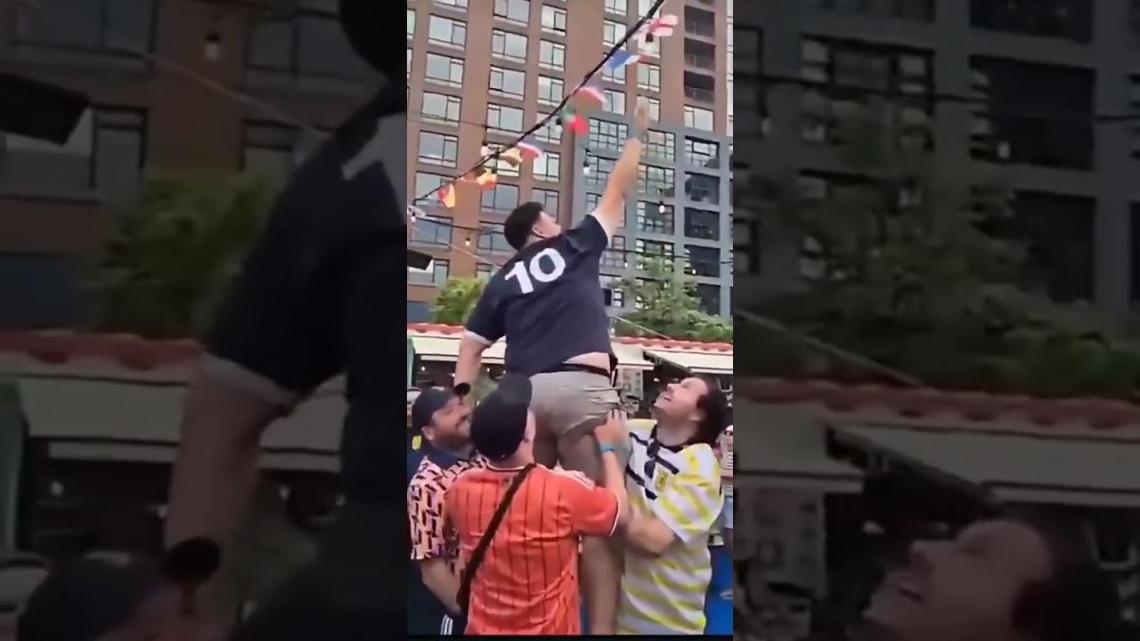Scotland fans pulling down the England flag from the bunting in Boston