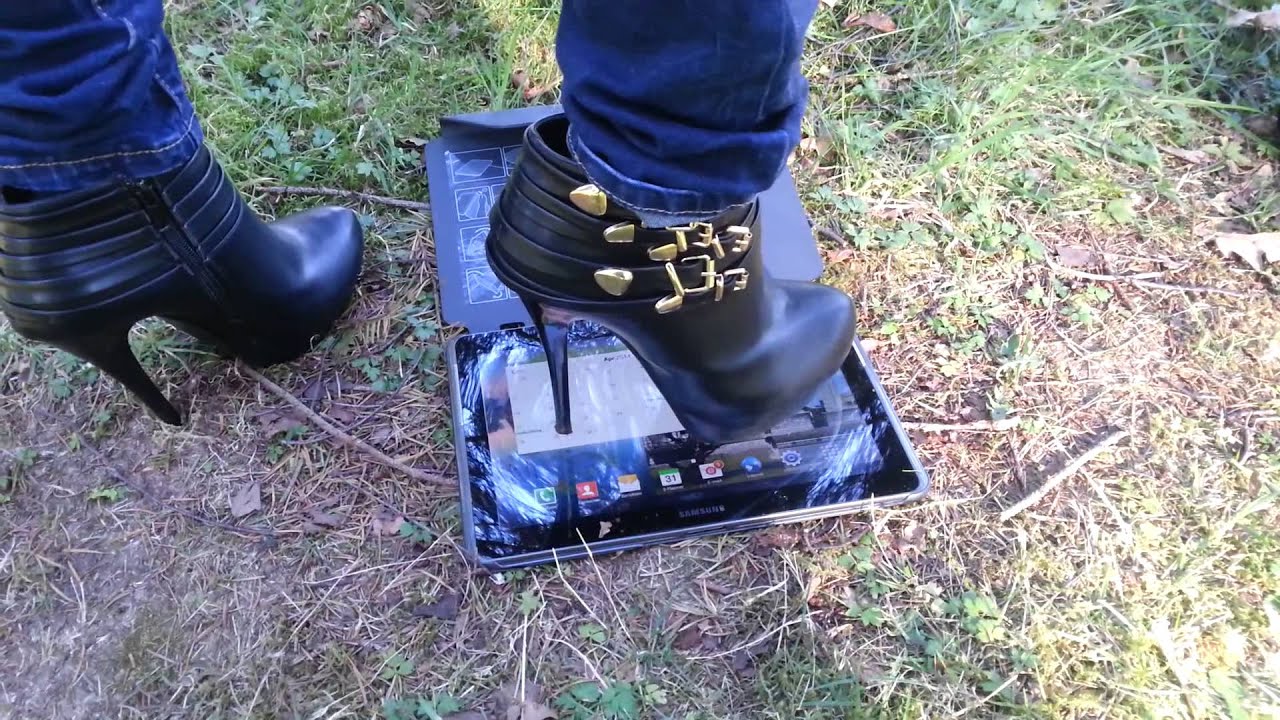 2 girls are trying to crush 2 samsung tabs 10.1 in high heels