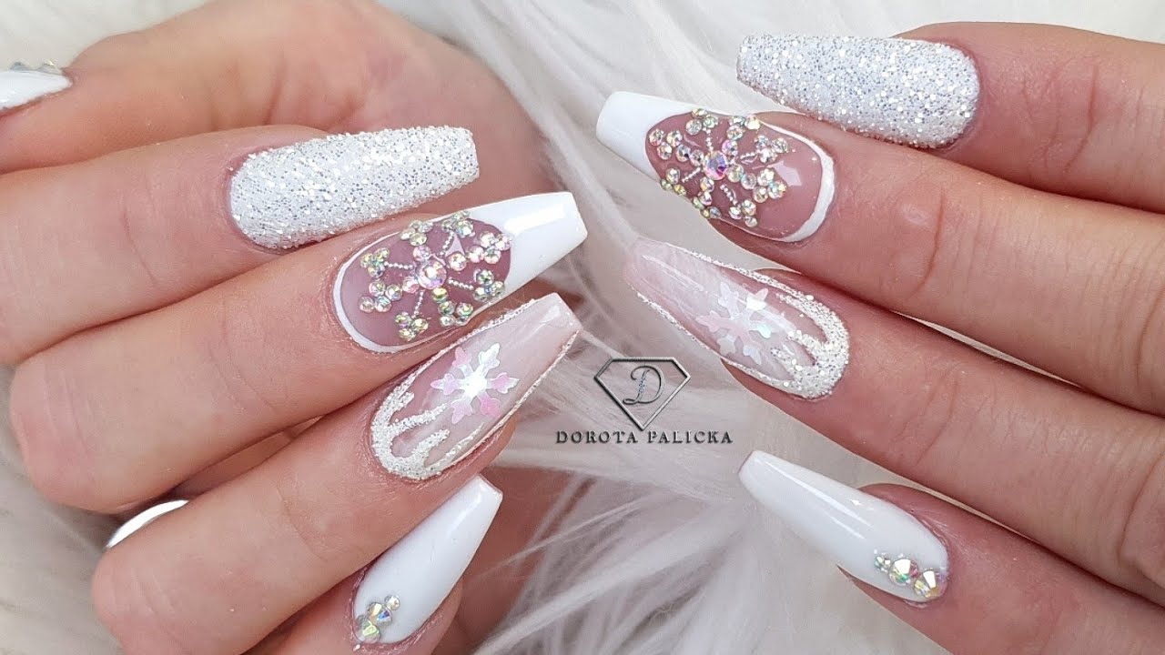 White nails with Crystals snowflakes. Winter nails. Nails trends 2022